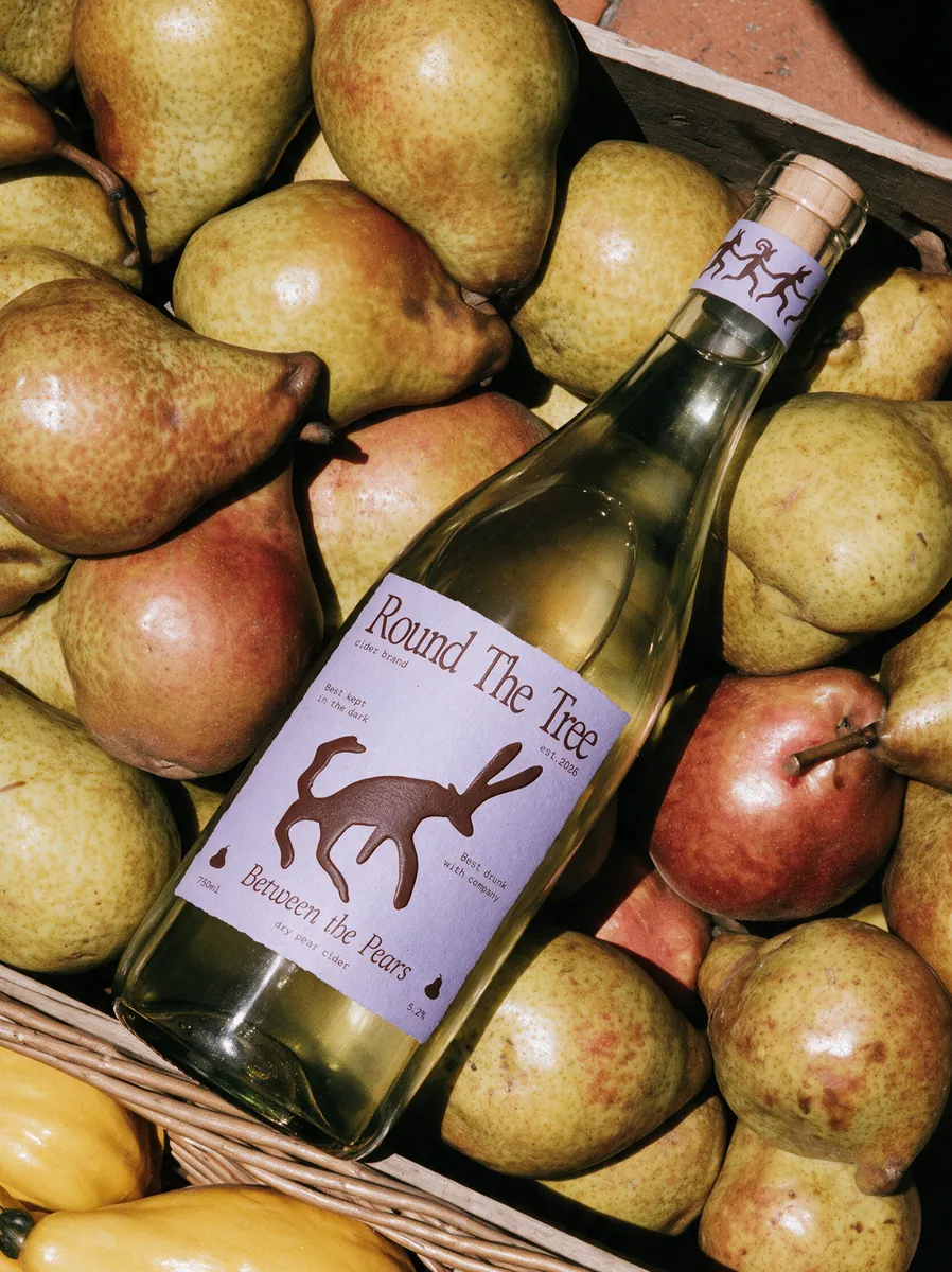 Cider bottle among pears